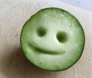 little smiling face carved from a cucumber