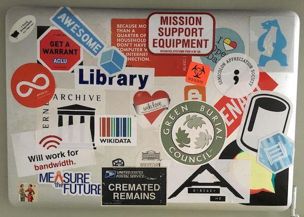 laptop top, covered in stickers
