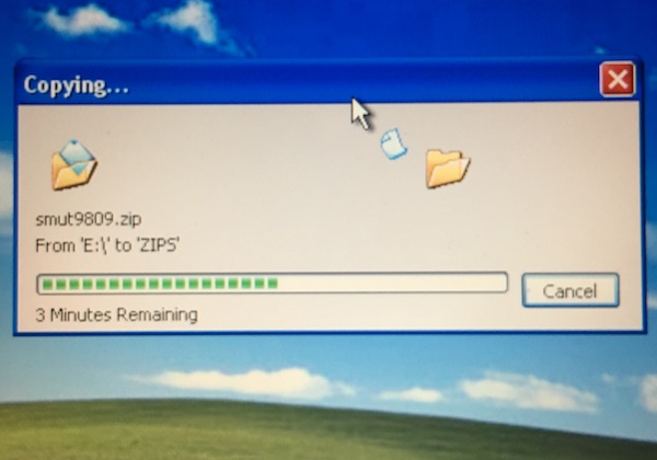 a screenshot of a Windows NT desktop showing the movement of a file called smut9908.zip 
