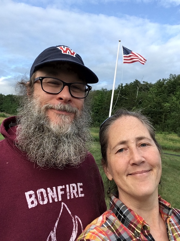 Me and Jim, outside, standing in front of an American flag