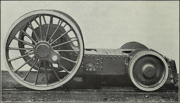 old newspaper image of some kind of chassis for a train or something. all you see are the wheels